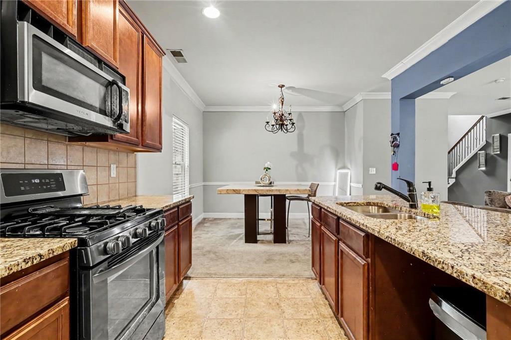 2780 Lakeview Walk Decatur, GA 30035 - Photo 12 of 37 a kitchen with stainless steel appliances granite countertop a sink stove and microwave