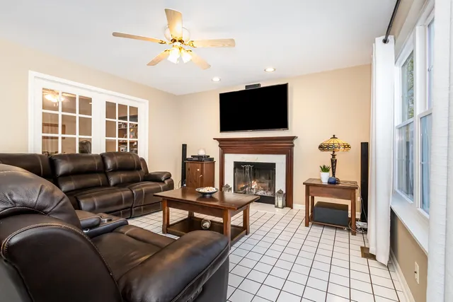 a living room with furniture a fireplace and a flat screen tv