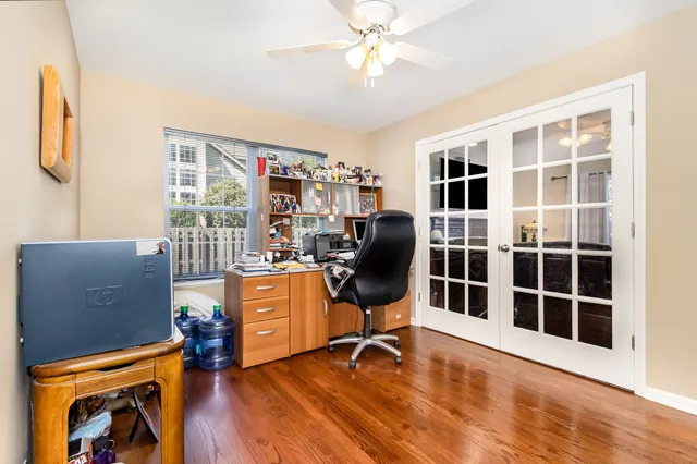a view of workspace with wooden floor and windows