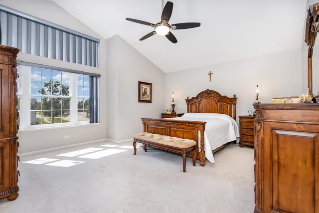 a bedroom with a bed dresser and a window