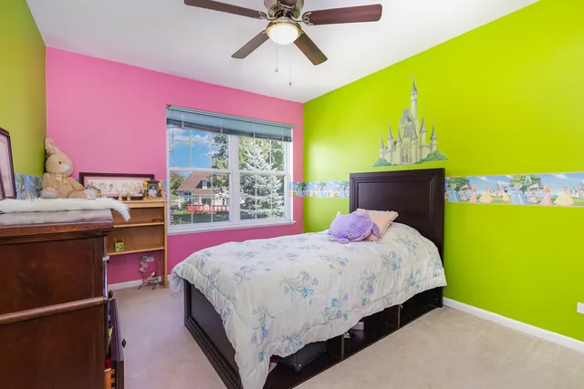 a bedroom with a bed dresser and a window