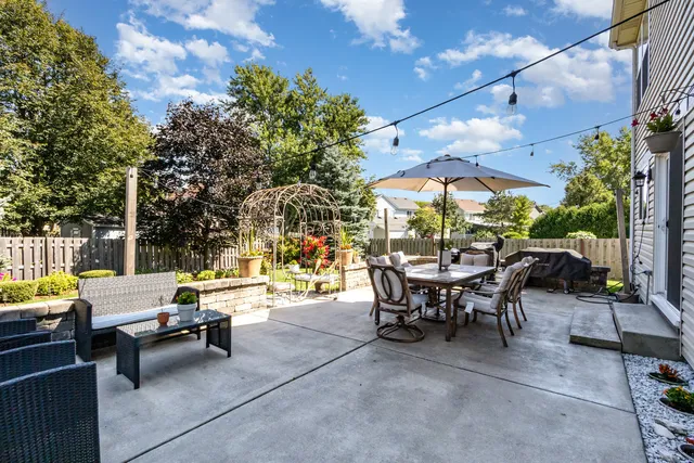 a view of a patio with swimming pool and sitting area