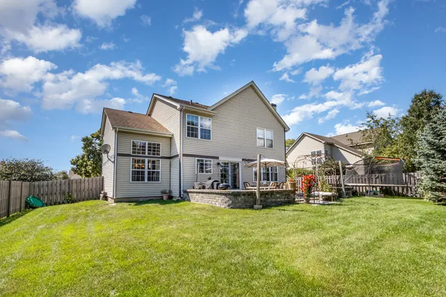 a front view of house with yard barbeque and outdoor seating