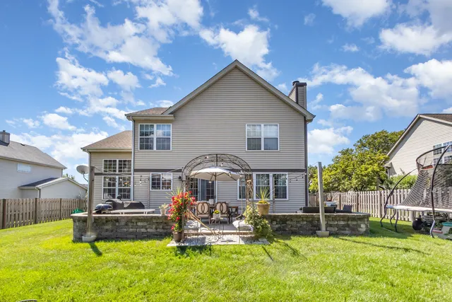 a front view of a house with a yard table and chairs