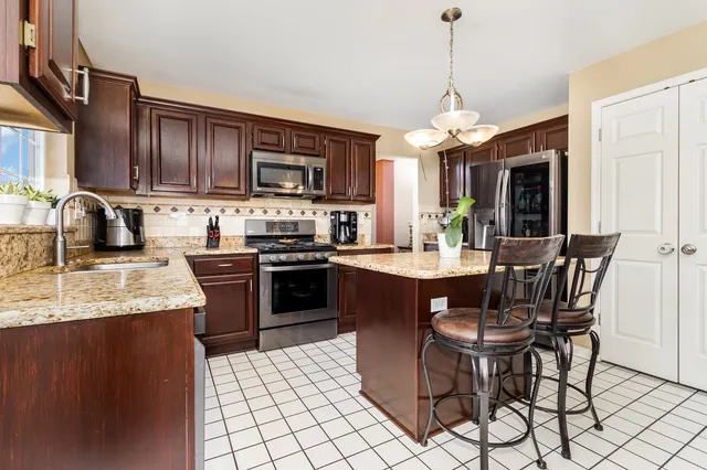 a kitchen with a dining table and chairs