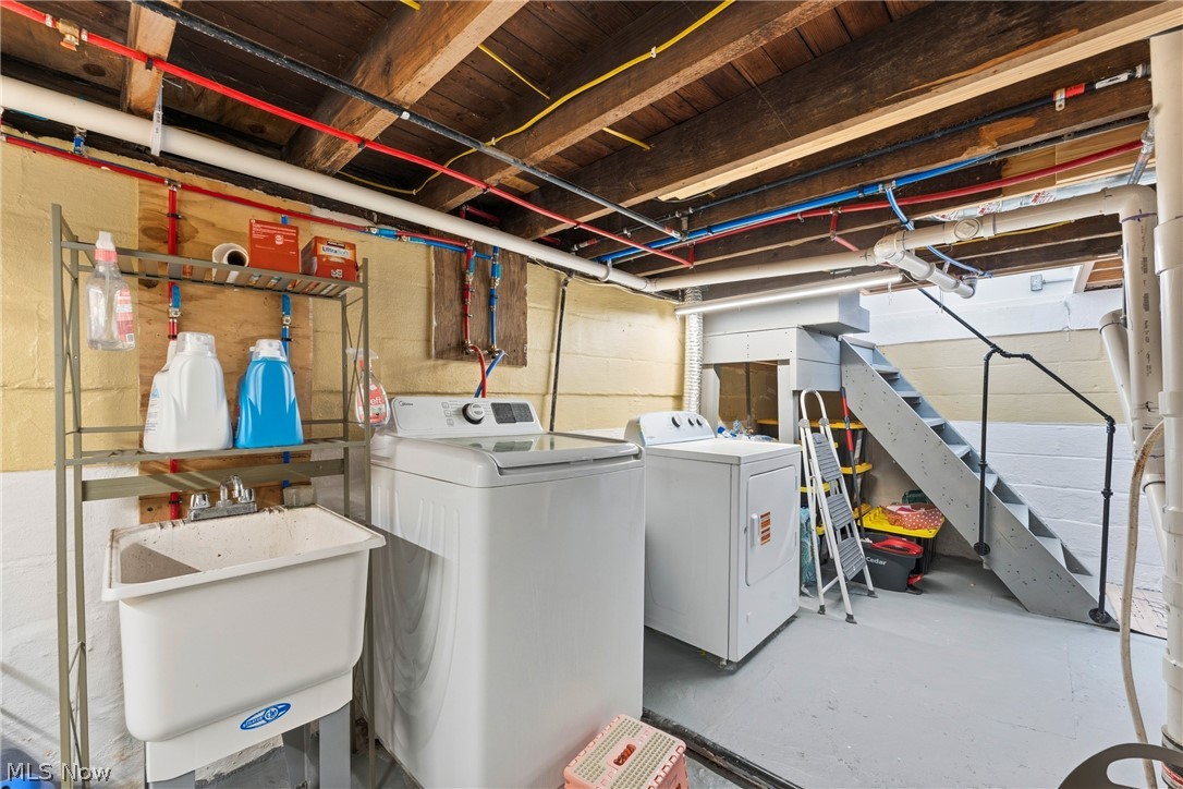 258 Randolph Road Mogadore, OH 44260 - Photo 25 of 49 Utility area featuring a laundry sink, exposed wood ceiling joists, and exposed plumbing