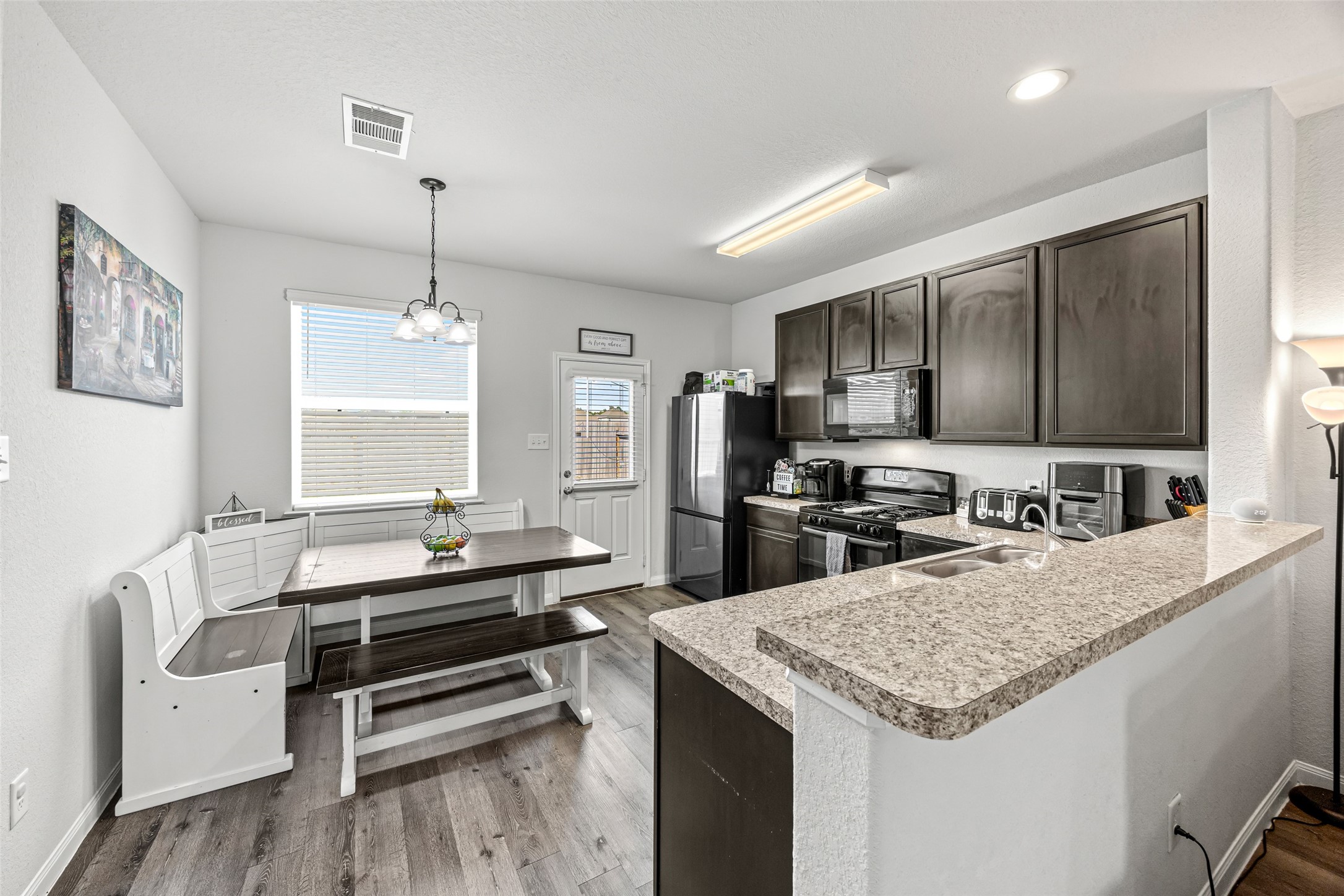 4827 Purple Wisteria Lane Spring, TX 77373 - Photo 11 of 26 a kitchen with sink stove and refrigerator
