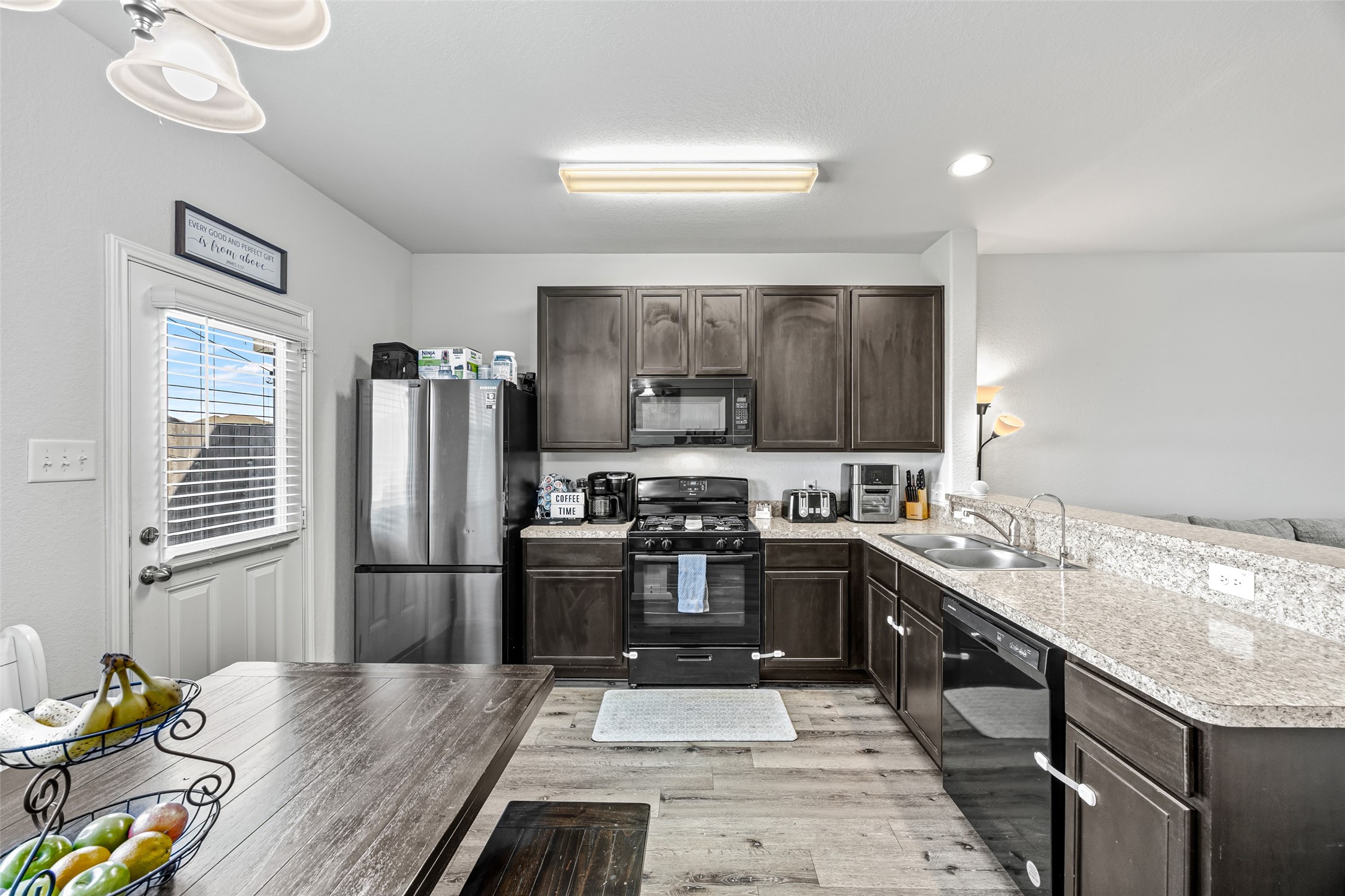 4827 Purple Wisteria Lane Spring, TX 77373 - Photo 12 of 26 a kitchen with granite countertop a refrigerator stove and sink
