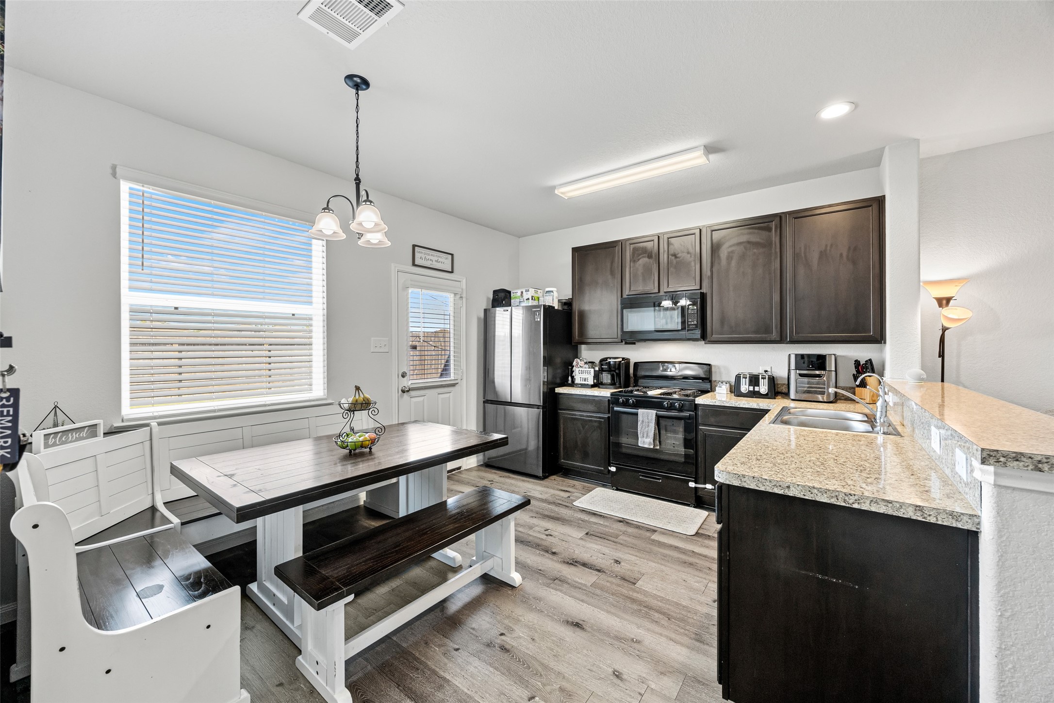 4827 Purple Wisteria Lane Spring, TX 77373 - Photo 15 of 26 a kitchen with sink refrigerator and cabinets