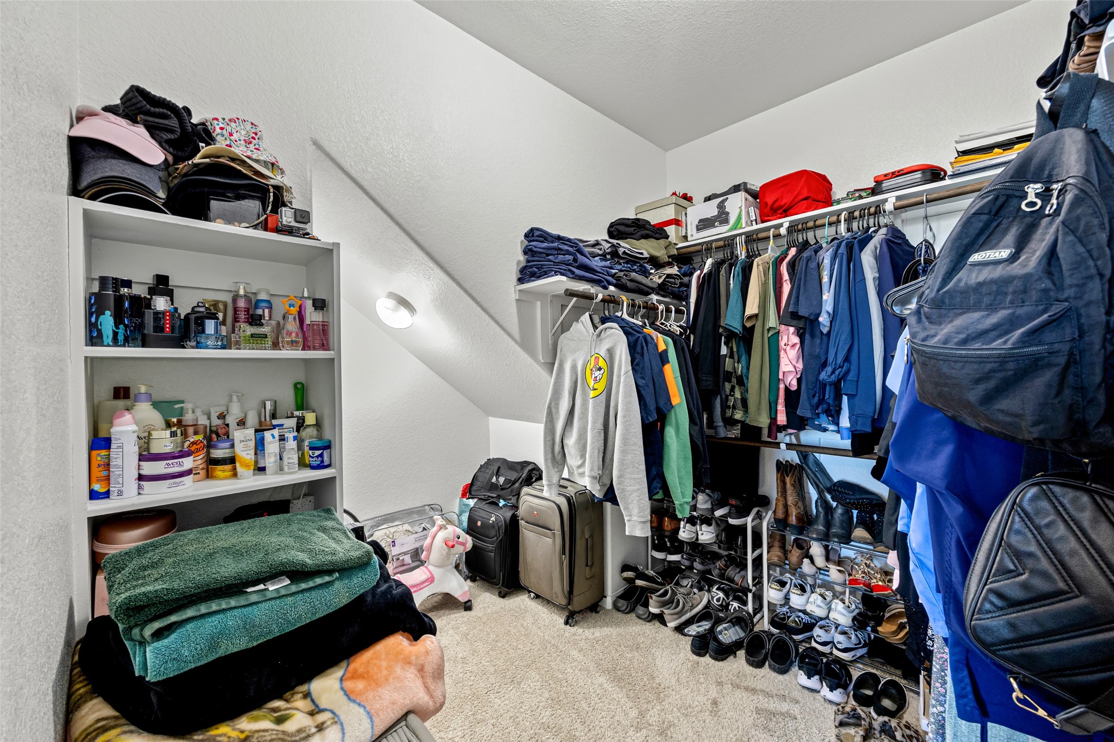 4827 Purple Wisteria Lane Spring, TX 77373 - Photo 18 of 26 a view of walk in closet with clothes and shoes