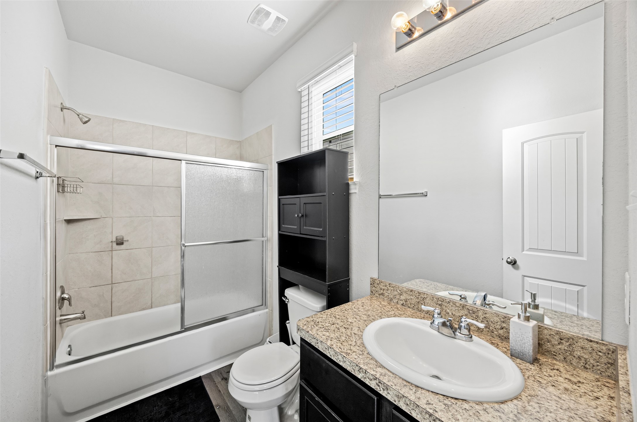 4827 Purple Wisteria Lane Spring, TX 77373 - Photo 19 of 26 a bathroom with a sink toilet and shower