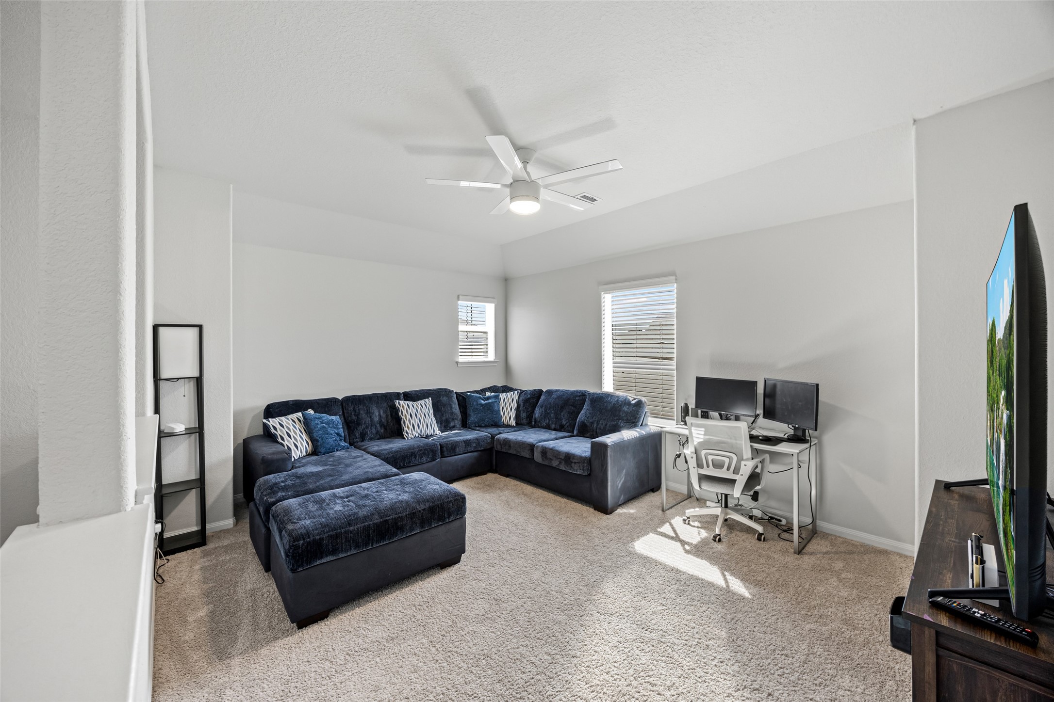 4827 Purple Wisteria Lane Spring, TX 77373 - Photo 20 of 26 a living room with furniture a flat screen tv and a window
