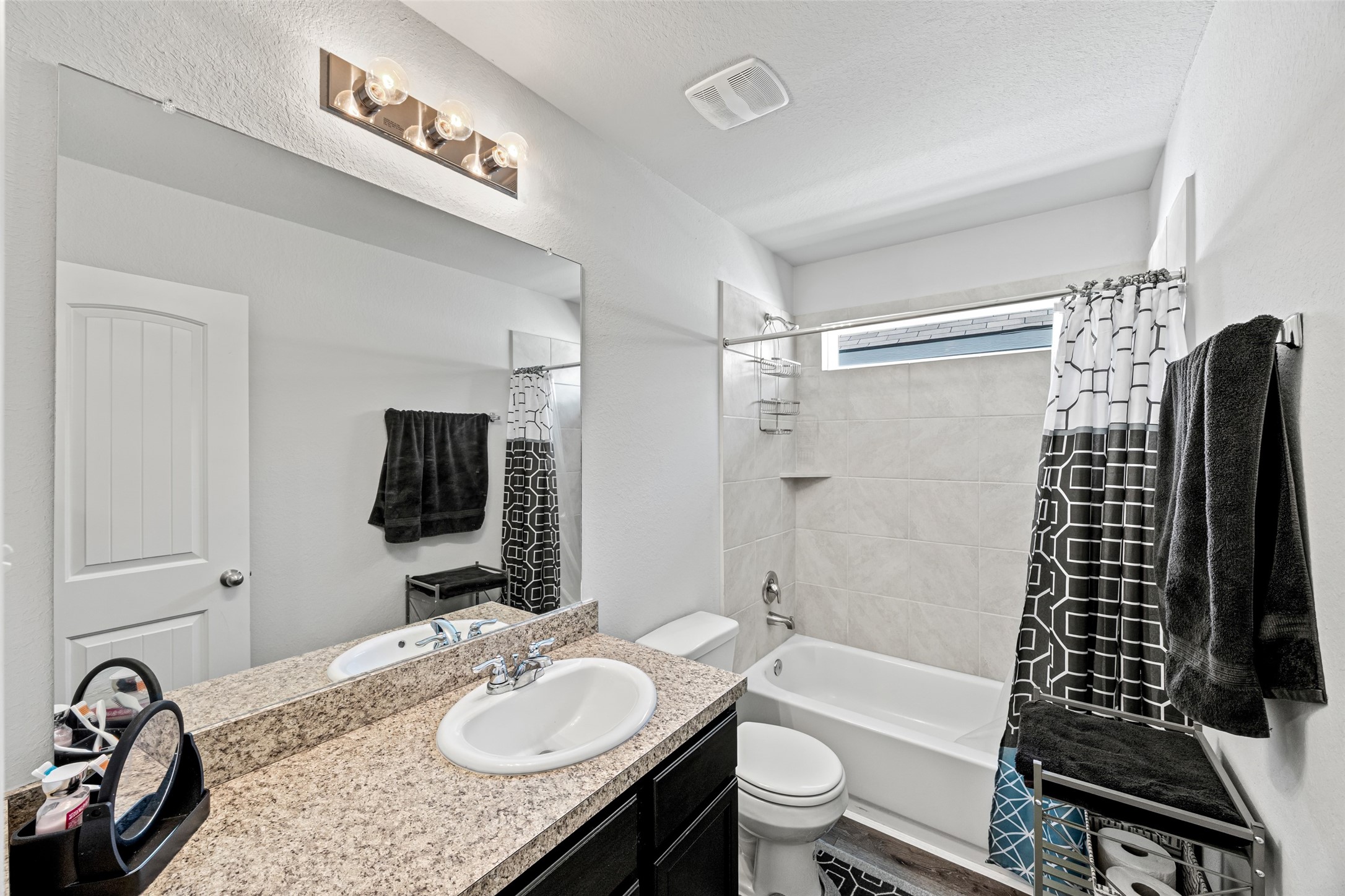 4827 Purple Wisteria Lane Spring, TX 77373 - Photo 23 of 26 a bathroom with a granite countertop sink toilet and shower