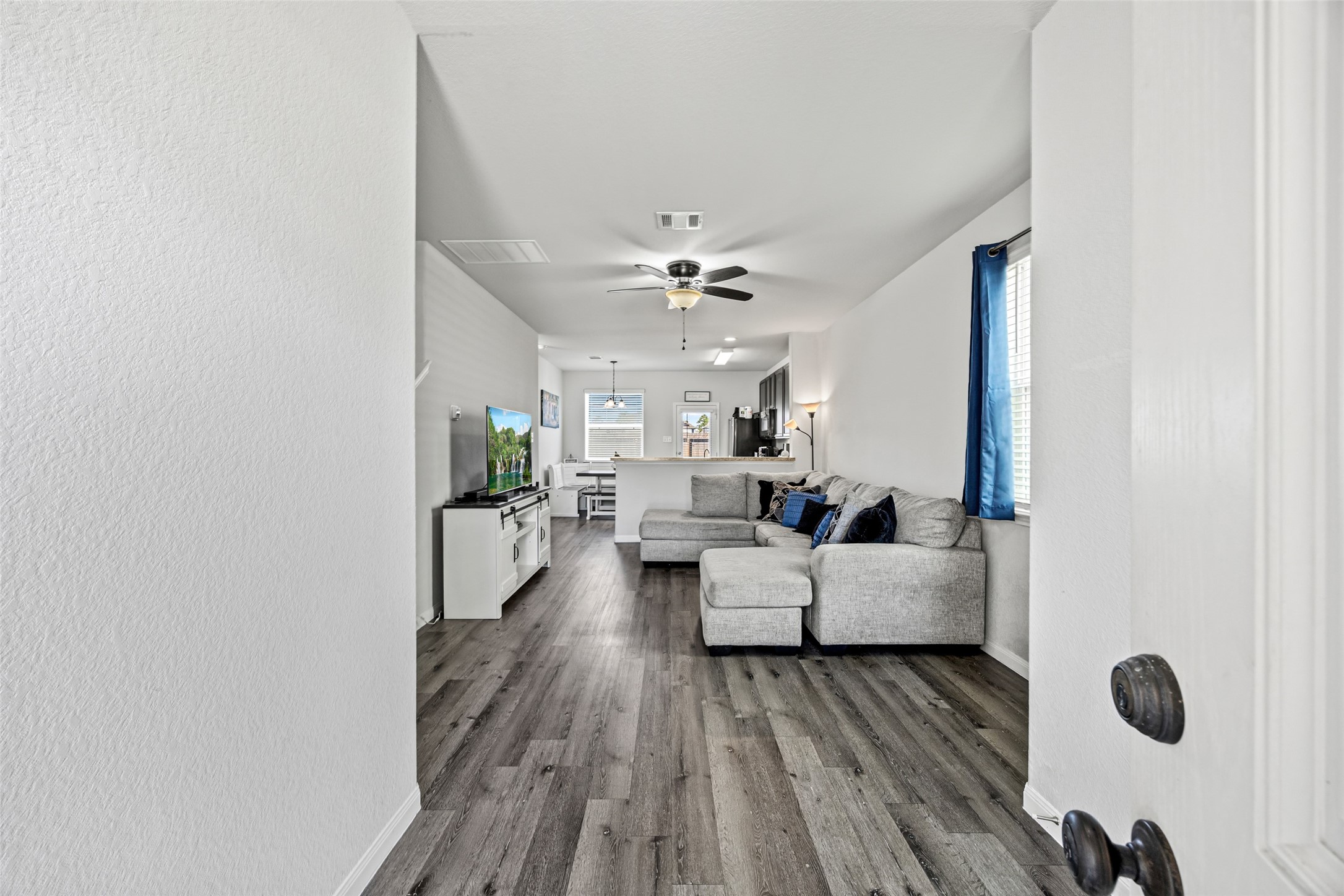4827 Purple Wisteria Lane Spring, TX 77373 - Photo 5 of 26 a living room with furniture and a chandelier