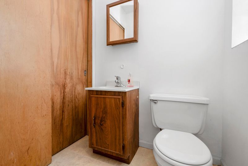 7213 West 109th Street Worth, IL 60482 - Photo 12 of 23 a white toilet sitting next to a bathroom sink