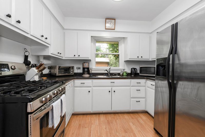 7213 West 109th Street Worth, IL 60482 - Photo 2 of 23 a kitchen with stainless steel appliances granite countertop a stove a sink dishwasher and a refrigerator
