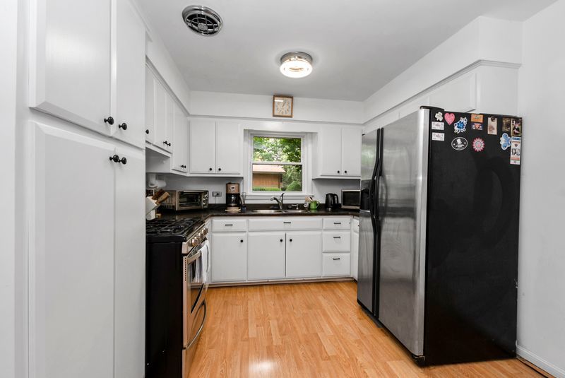 7213 West 109th Street Worth, IL 60482 - Photo 3 of 23 a kitchen with stainless steel appliances a refrigerator sink and cabinets
