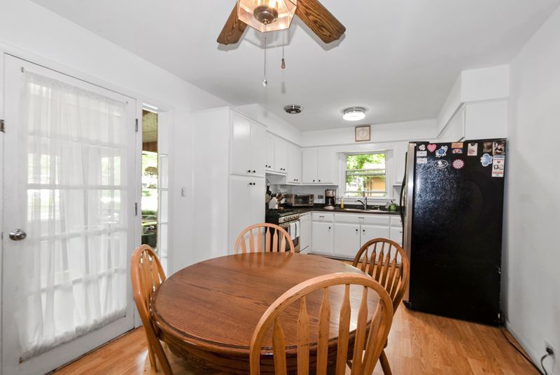 7213 West 109th Street Worth, IL 60482 - Photo 4 of 23 a dining room with furniture a chandelier and wooden floor