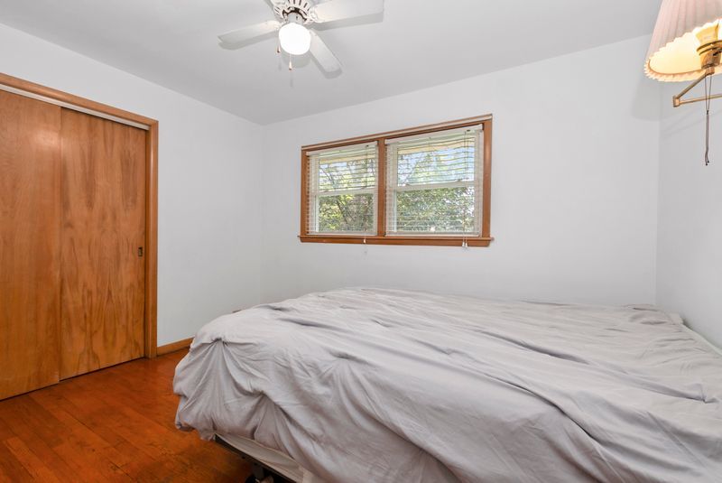 7213 West 109th Street Worth, IL 60482 - Photo 9 of 23 a bedroom with a bed and a window