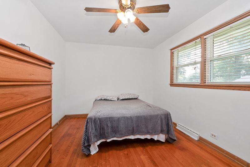7213 West 109th Street Worth, IL 60482 - Photo 10 of 23 a bedroom with a bed and wooden floor