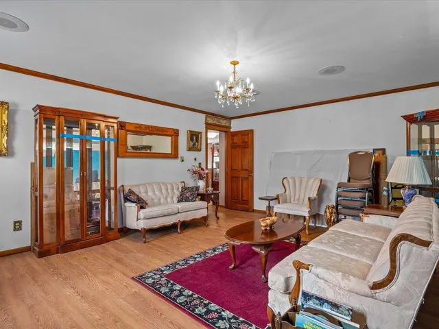 a living room with furniture a rug and a chandelier