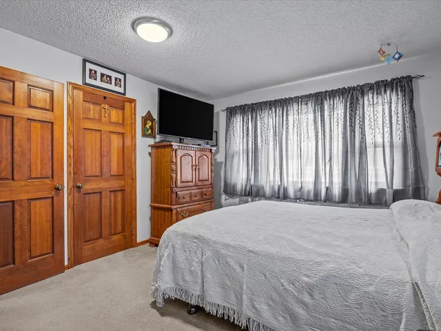 a bedroom with a bed and a television