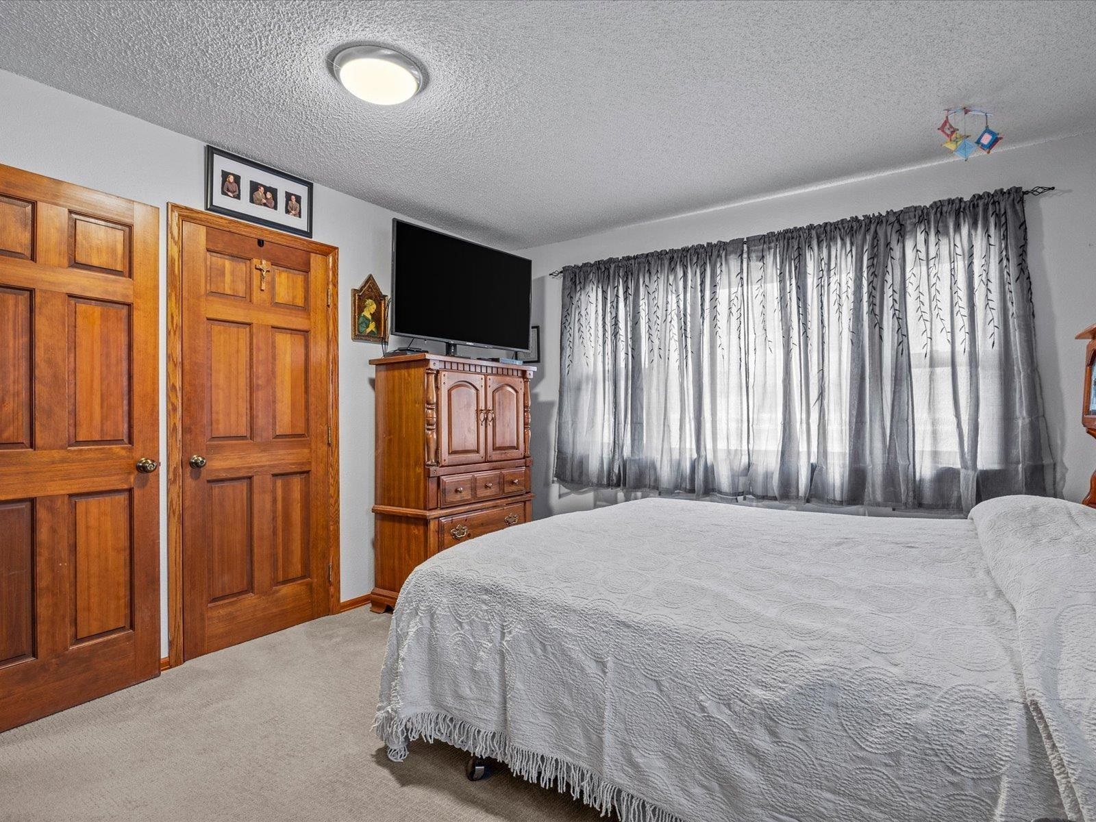 3085 F F 1/2 Road Grand Junction, CO 81504 - Photo 13 of 30 a bedroom with a bed and a television