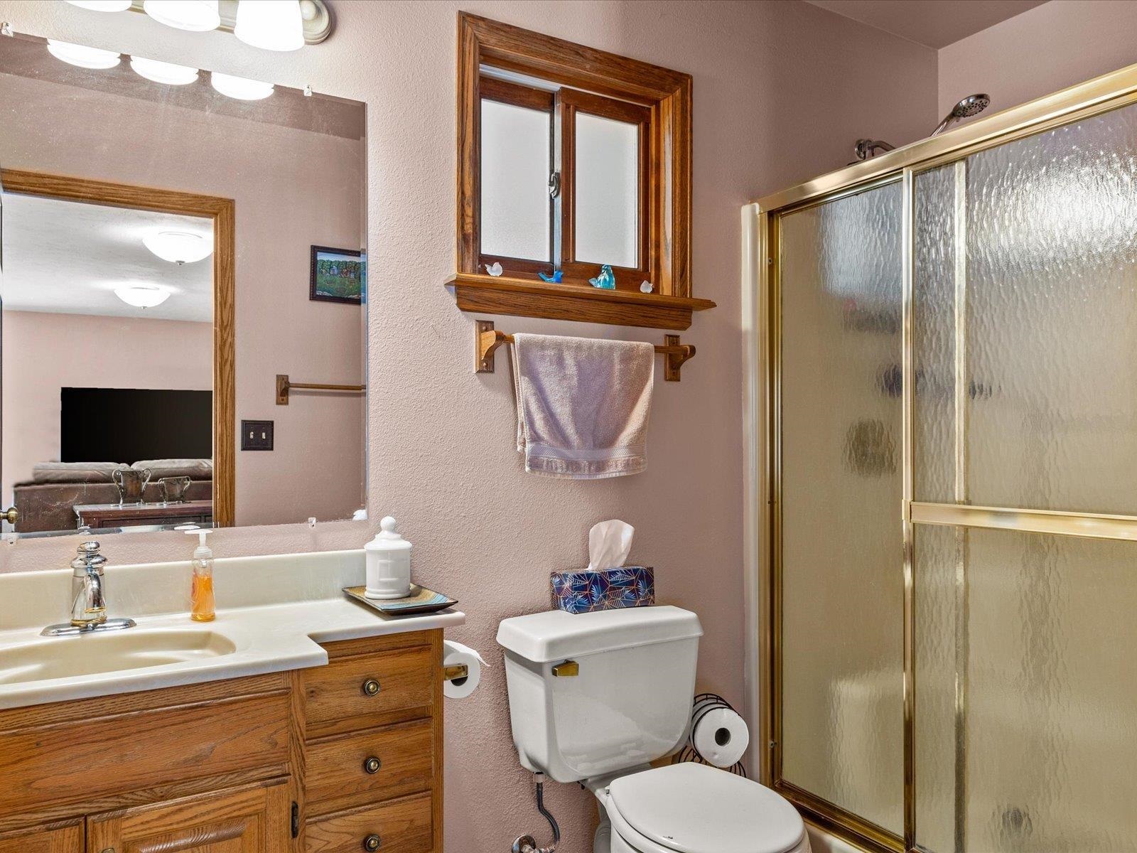3085 F F 1/2 Road Grand Junction, CO 81504 - Photo 16 of 30 a bathroom with a granite countertop toilet a sink and a mirror