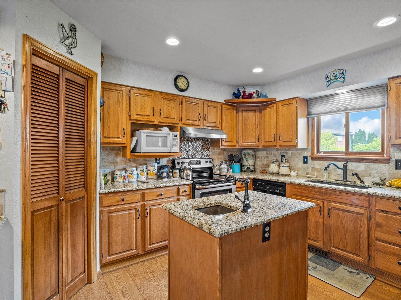 3085 F F 1/2 Road Grand Junction, CO 81504 - Photo 7 of 30 a kitchen with stainless steel appliances granite countertop a sink stove and cabinets