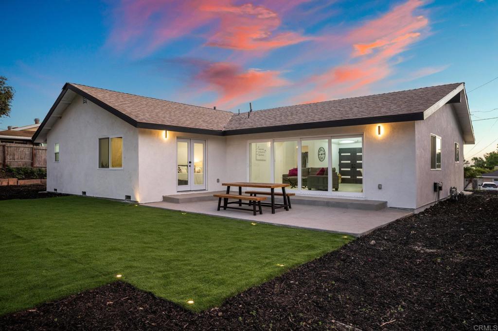 1326 Crestridge Drive Oceanside, CA 92054 - Photo 17 of 29 a view of a backyard with table and chairs and potted plants