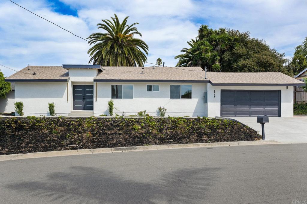1326 Crestridge Drive Oceanside, CA 92054 - Photo 24 of 29 a front view of a house with a yard and garage