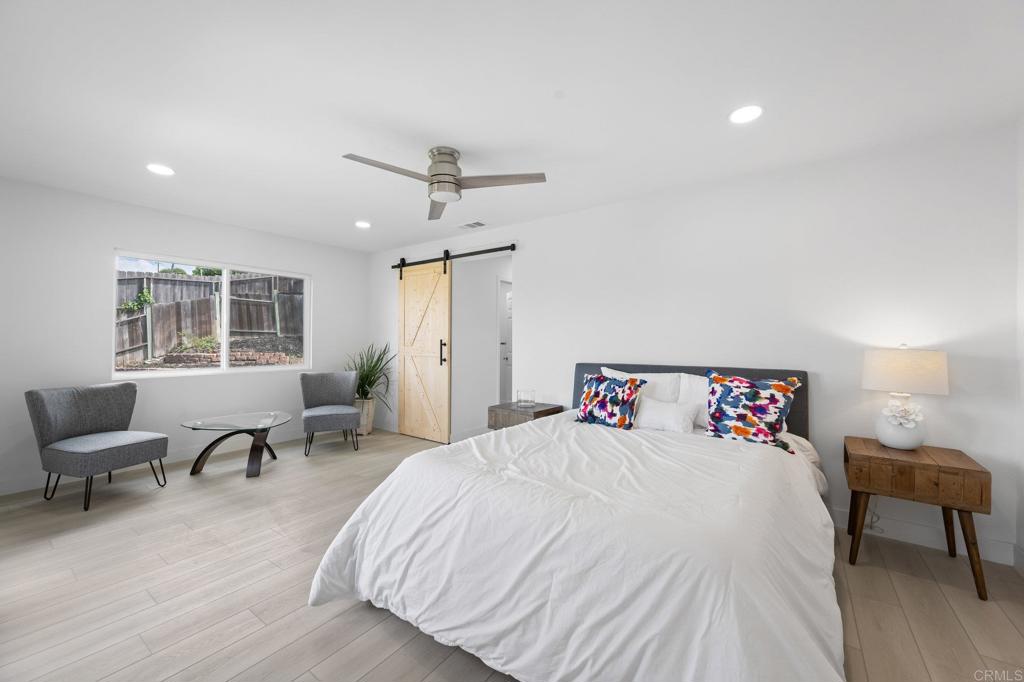 1326 Crestridge Drive Oceanside, CA 92054 - Photo 25 of 29 a bedroom with a bed and wooden floor