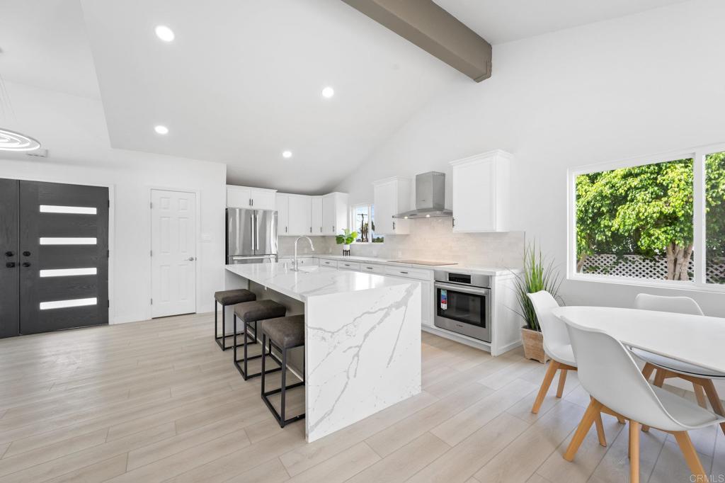 1326 Crestridge Drive Oceanside, CA 92054 - Photo 7 of 29 a kitchen with a table chairs a sink dishwasher window and cabinets