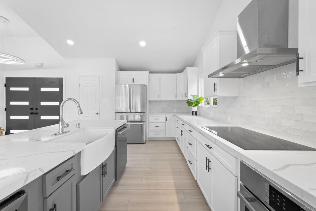 1326 Crestridge Drive Oceanside, CA 92054 - Photo 8 of 29 a large kitchen with stainless steel appliances lots of counter space and wooden floors