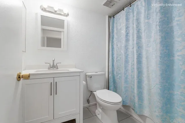 a white toilet sitting next to a white sink
