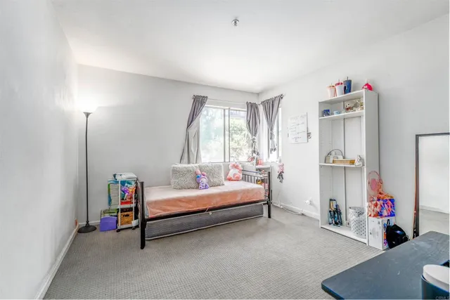 a bed room with a bed and a window