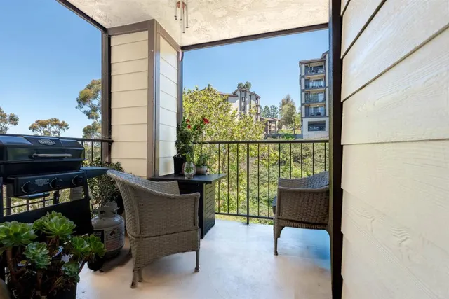 a view of a chairs and table in the balcony