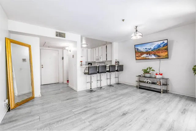 a living room with furniture and kitchen view