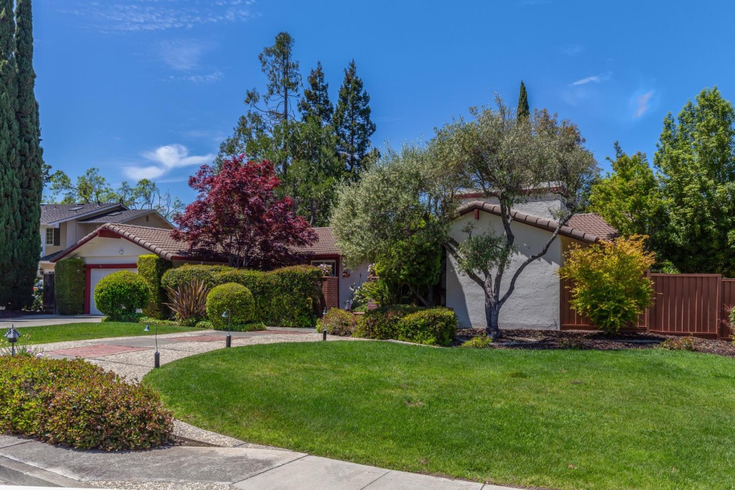 12464 Sheridan Circle Saratoga, CA 95070 - Photo 1 of 25 a view of a garden with a building in the background