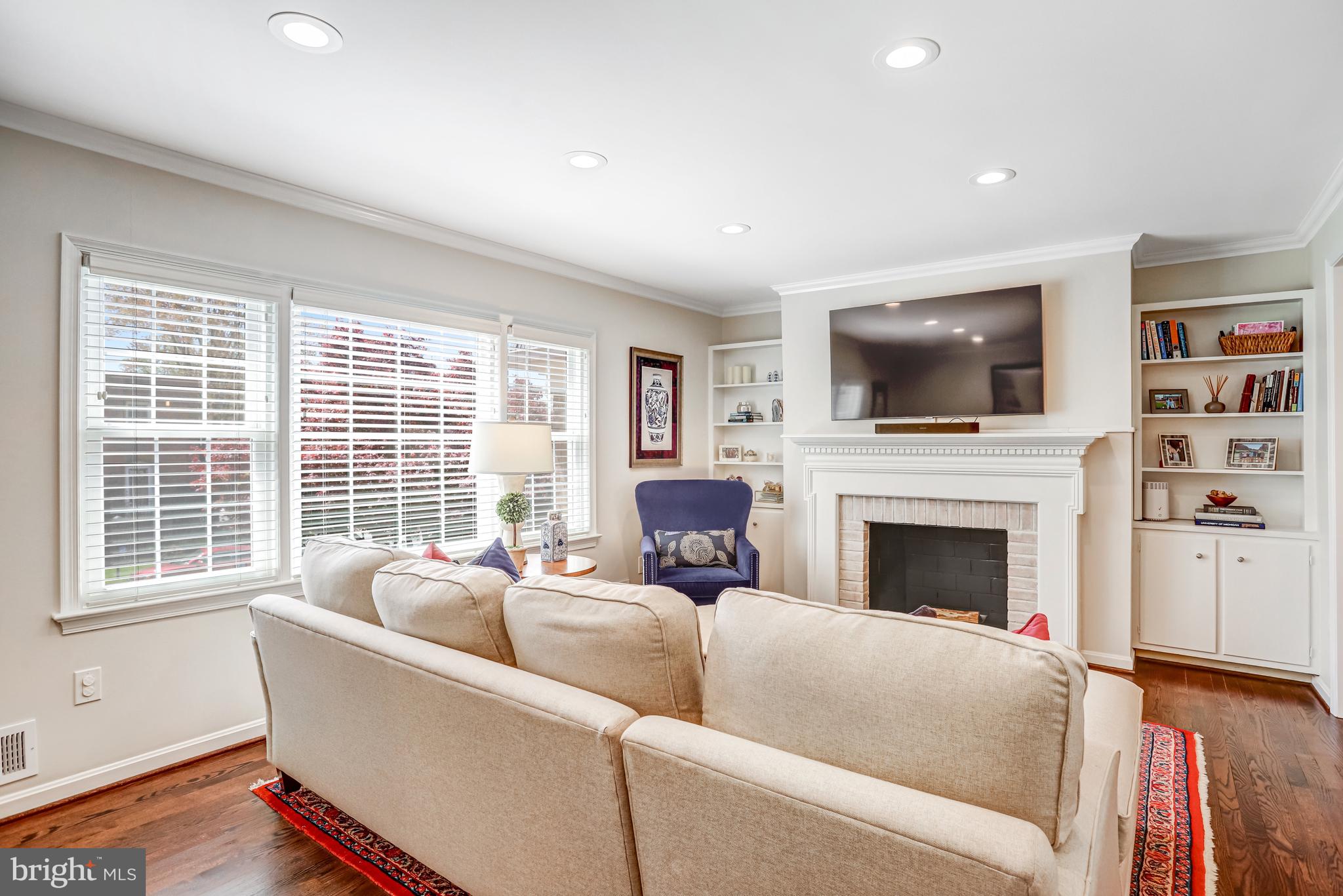 6737 Baron Road McLean, VA 22101 - Photo 13 of 36 a living room with furniture a flat screen tv and a fireplace