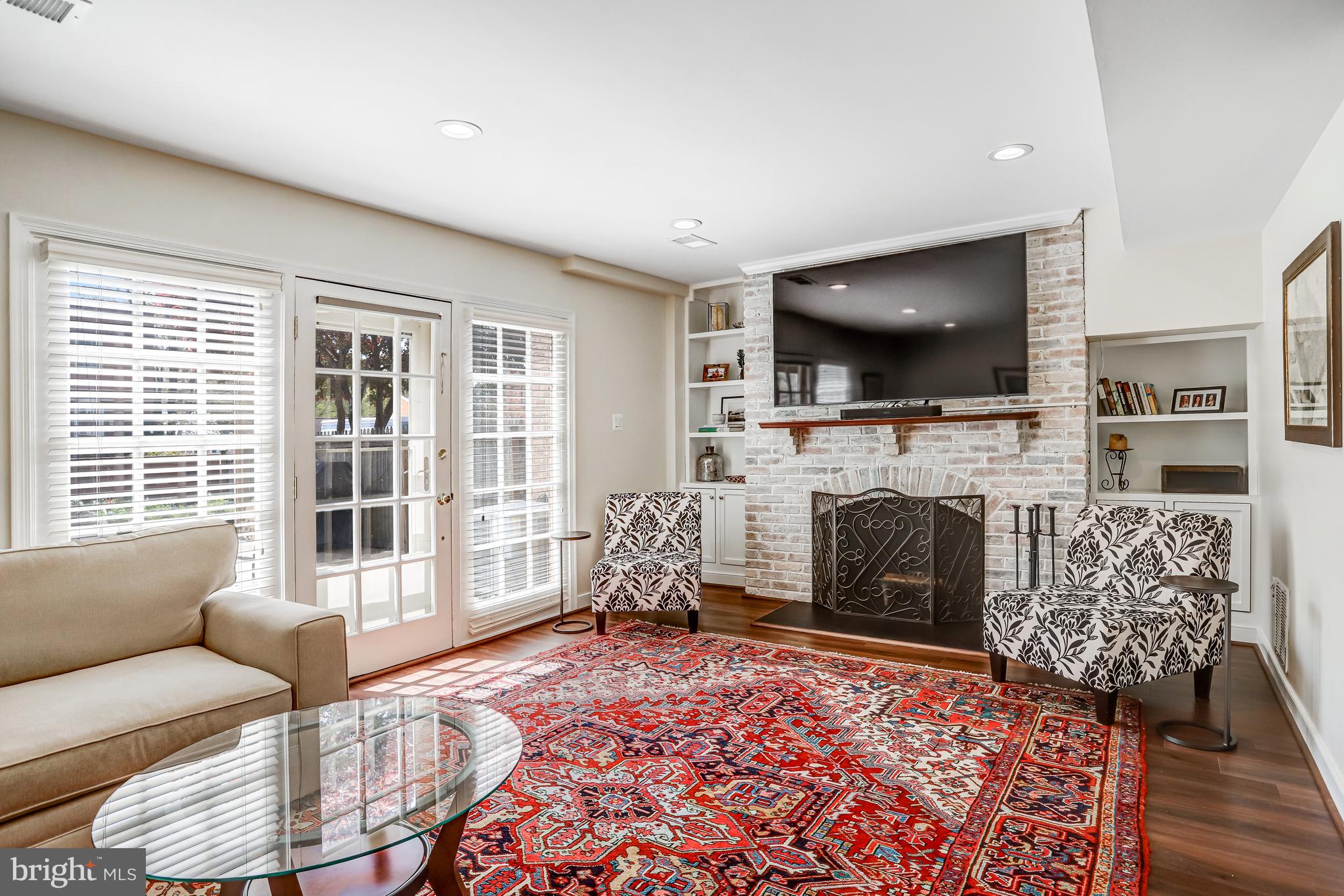 6737 Baron Road McLean, VA 22101 - Photo 27 of 36 a living room with furniture a flat screen tv and a fireplace