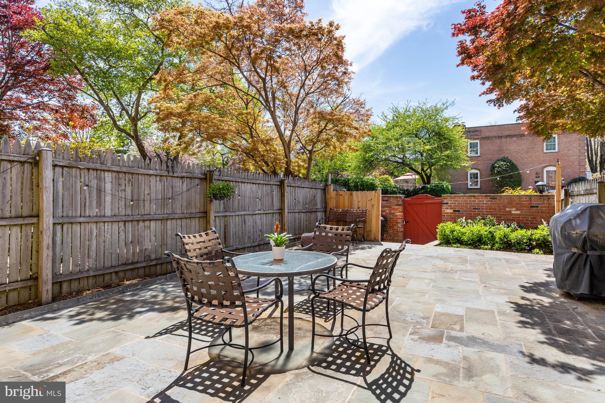 6737 Baron Road McLean, VA 22101 - Photo 32 of 36 a patio with a table and chairs and potted plants