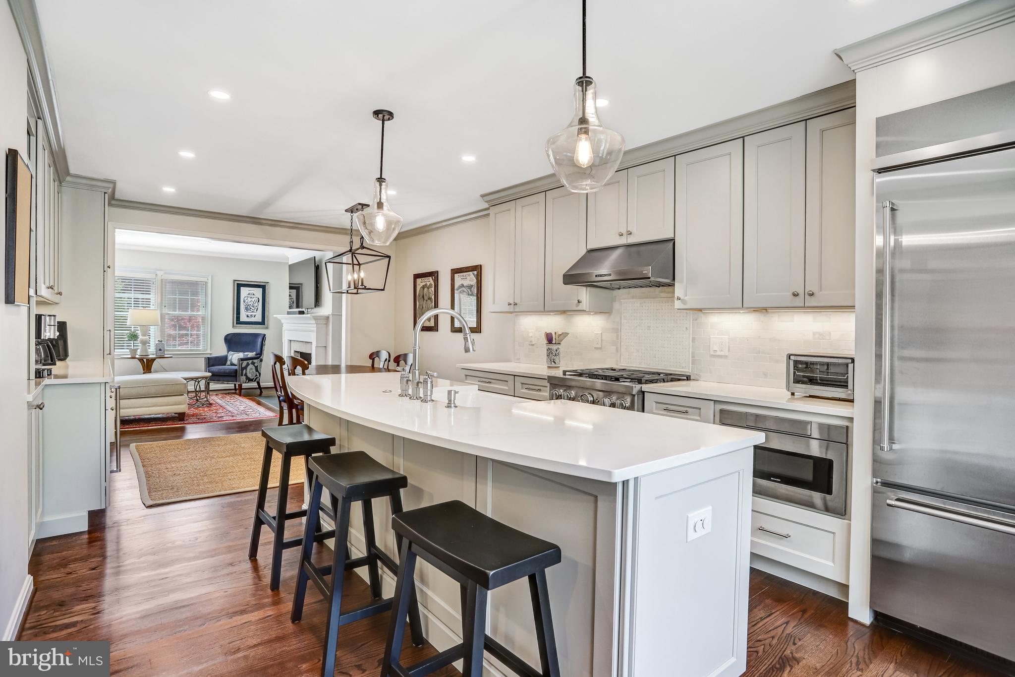 6737 Baron Road McLean, VA 22101 - Photo 6 of 36 a kitchen with stainless steel appliances granite countertop a stove refrigerator and cabinets