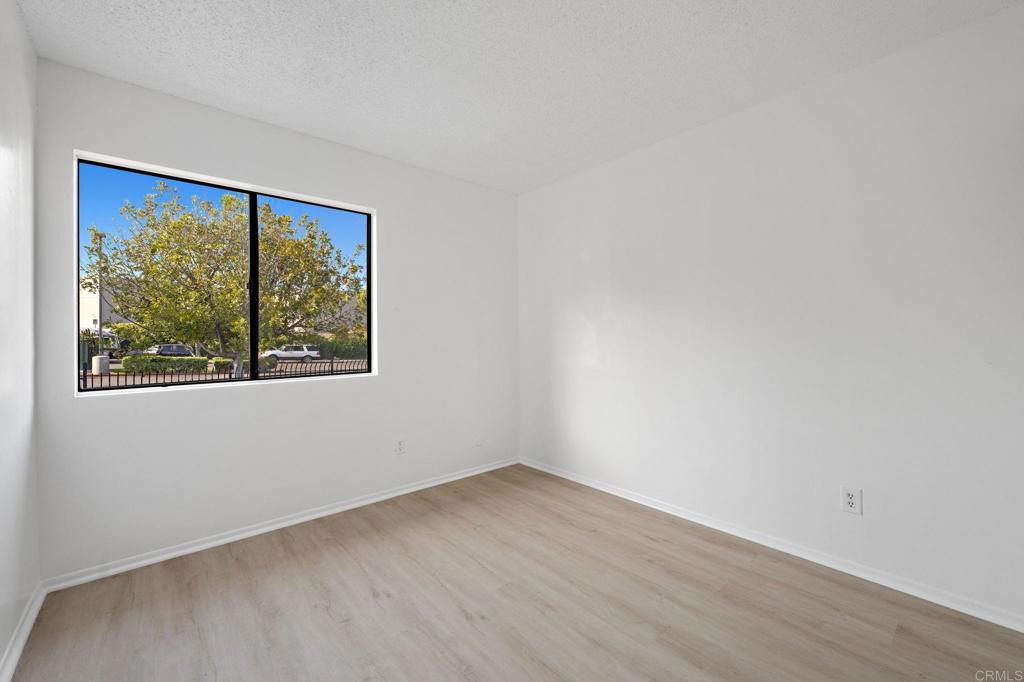 3408 Del Este Way Oceanside, CA 92056 - Photo 18 of 25 a view of an empty room with wooden floor and a window
