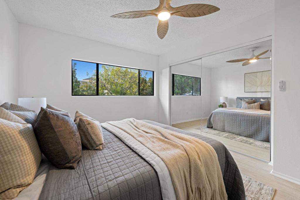 3408 Del Este Way Oceanside, CA 92056 - Photo 22 of 25 a bedroom with a bed and a chandelier