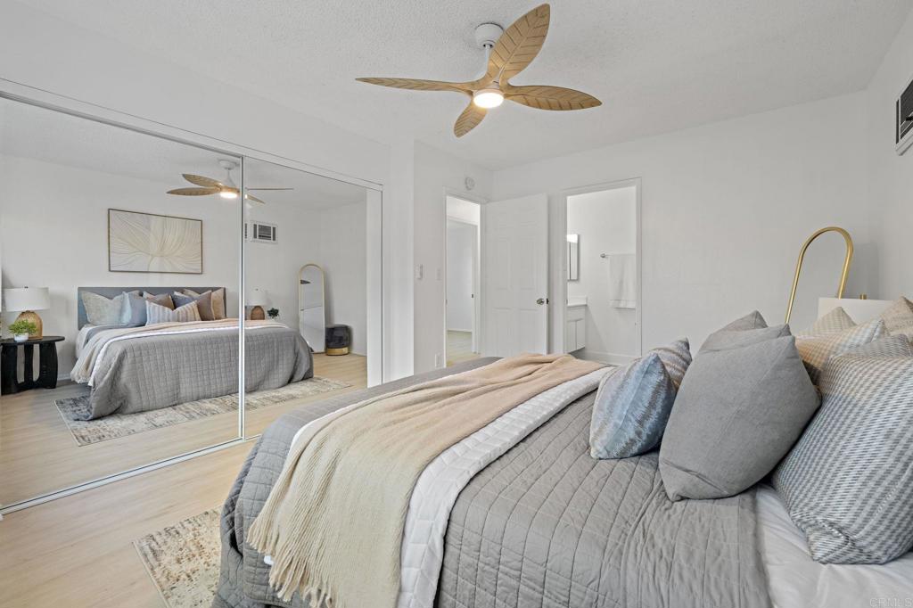 3408 Del Este Way Oceanside, CA 92056 - Photo 24 of 25 a large bed sitting in a bedroom and a chandelier