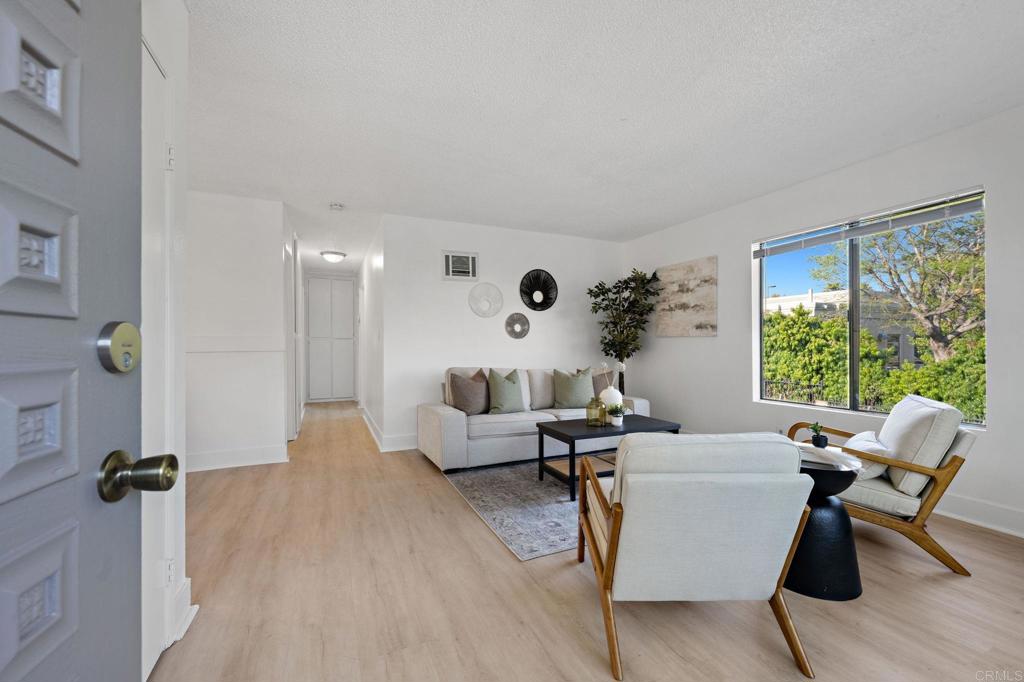 3408 Del Este Way Oceanside, CA 92056 - Photo 6 of 25 a living room with furniture large window and wooden floor