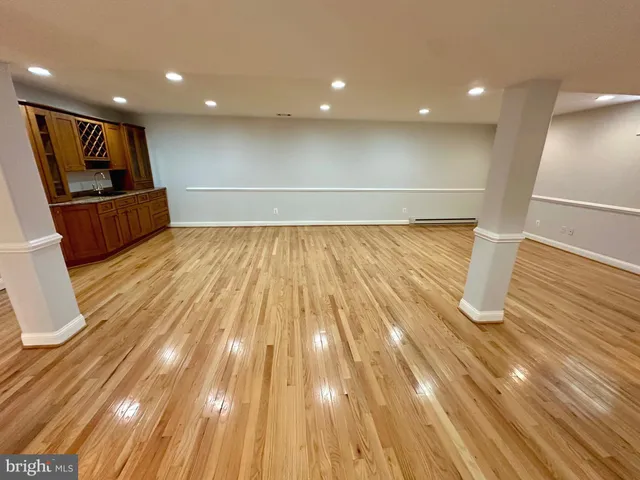 a view of kitchen with wooden floor and electronic appliances