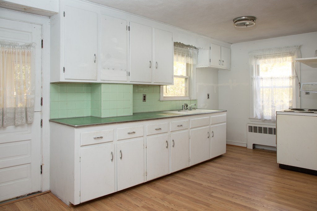 379 Marrett Road Lexington, MA 02421 - Photo 2 of 6 a kitchen with white cabinets white stainless steel appliances and sink