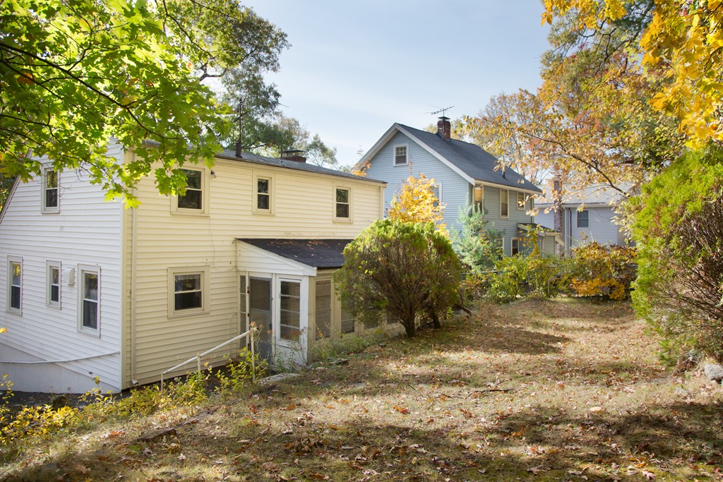 379 Marrett Road Lexington, MA 02421 - Photo 5 of 6 a view of a white house next to a yard with large trees